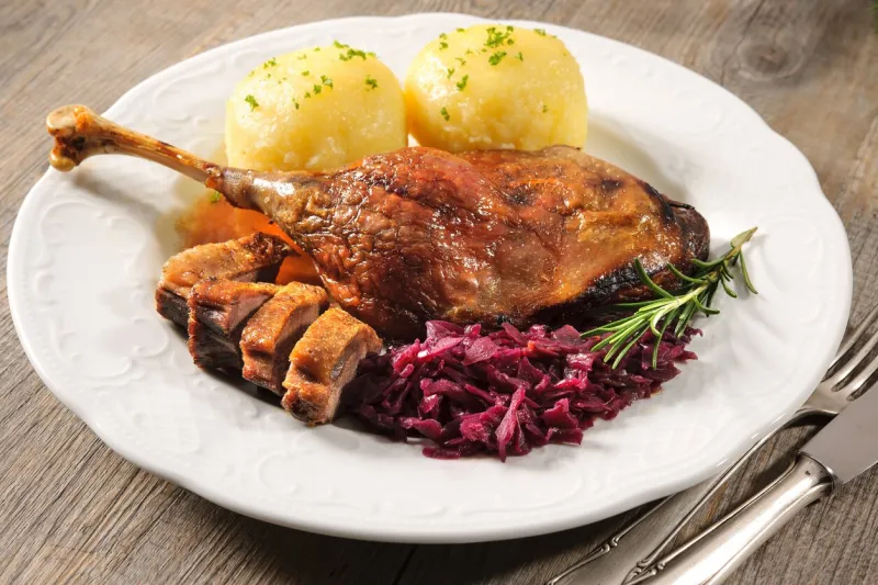 crusty goose leg with braised red cabbage and dumplings