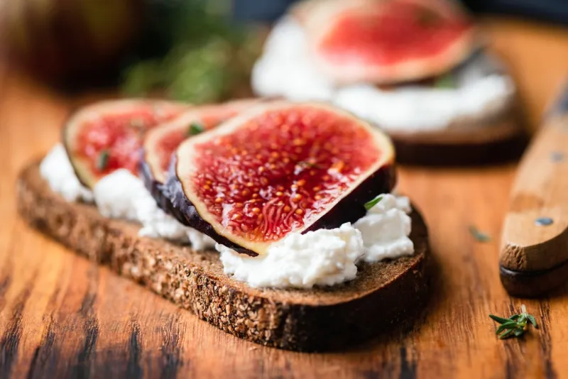 fig and ricotta rye bread toast healthy snack, appetizer or breakfast closeup view, selective focus