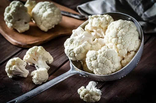 cauliflower in an old metal colander
