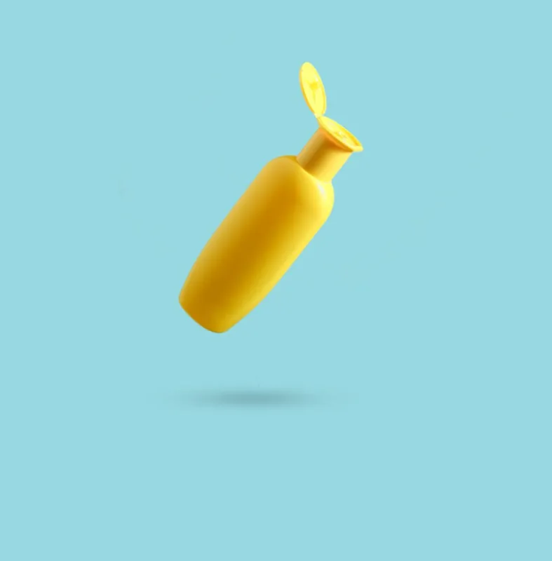 yellow bottle of shower gel on blue background minimalism, conceptual photo, photo with shadow