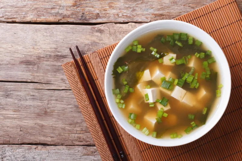 japanese miso soup in a white bowl horizontal top view