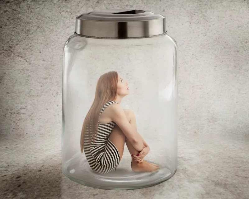 lack, violation of human rights liberty young lonely woman sitting in glass jar isolated grey wall background suppression of freedom, restrain, employee working conditions, life limitation concept