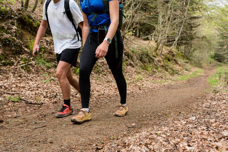 young couple hiking in the basque country near the holzarte footbridge