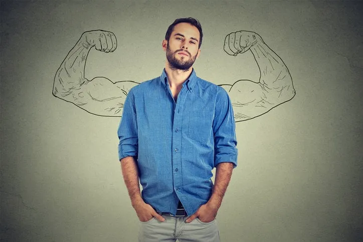 strong man, self confident young entrepreneur standing isolated on gray wall background arrogant bold self-important uppity snobbish stuck up man