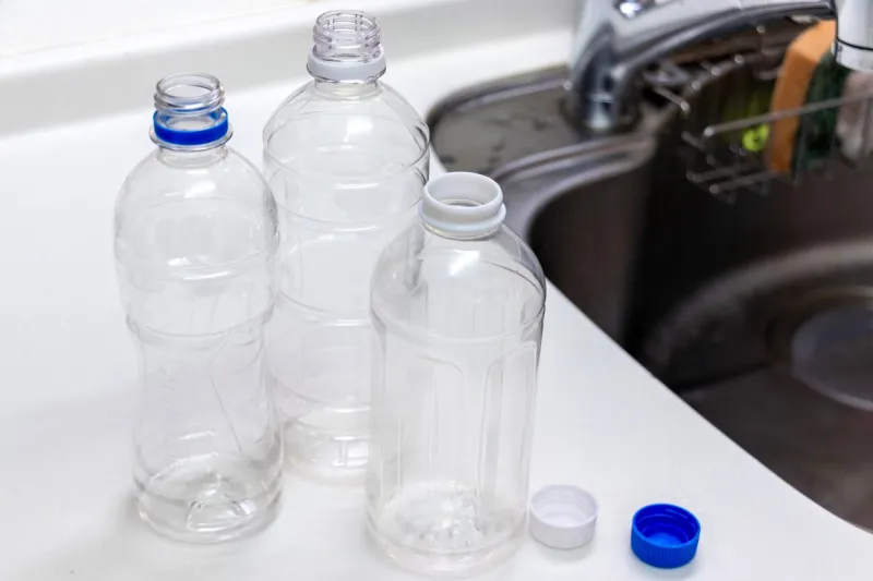 washing empty plastic bottles with water