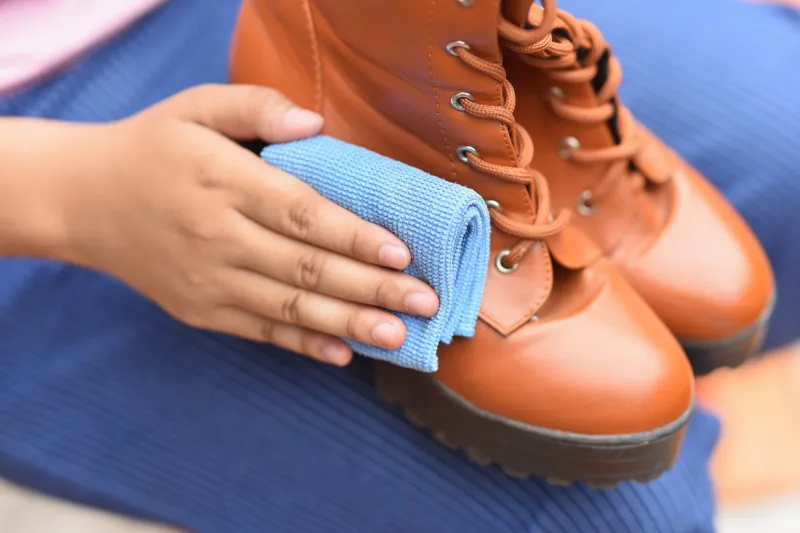 cleaning leather shoes with a polishing cloth