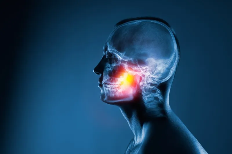 x-ray of a man's head on blue background medical examination of head injuries jaw joint is highlighted by yellow red colour others x-ray images in my portfolio