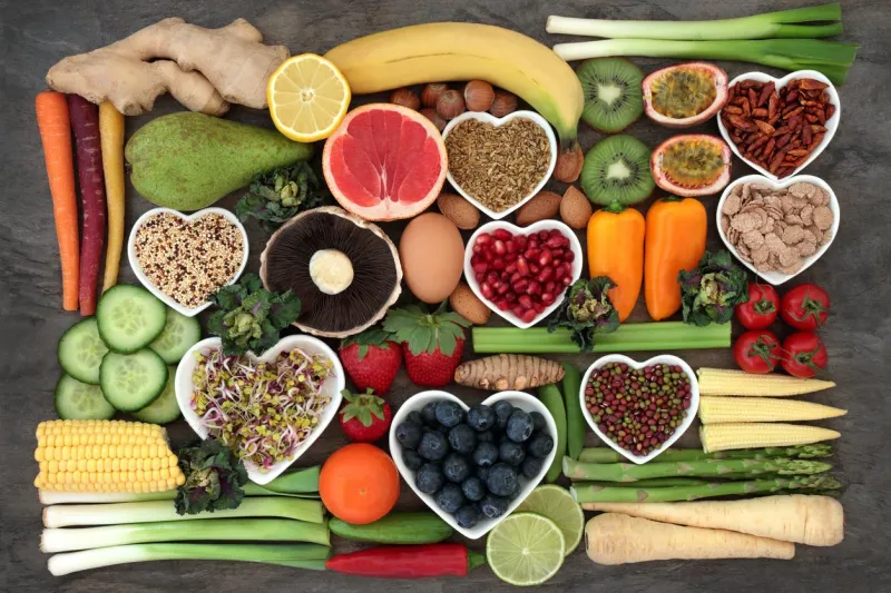 super food concept for a healthy diet with fruit and vegetables, dairy, spices, nuts, legumes, cereals and grains, high in antioxidants, anthocyanins, dietary fibre and vitamins