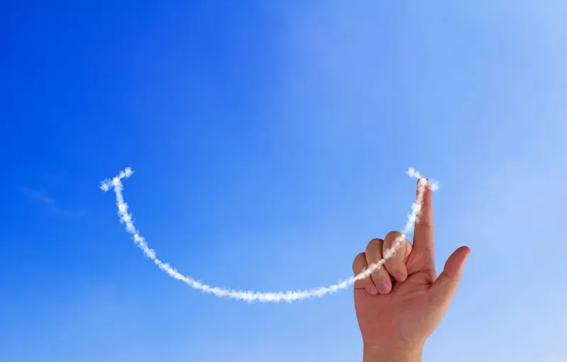 happiness concept, hand drawing smile cloud on blue sky background