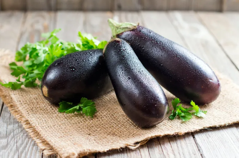 fresh eggplant on wooden background