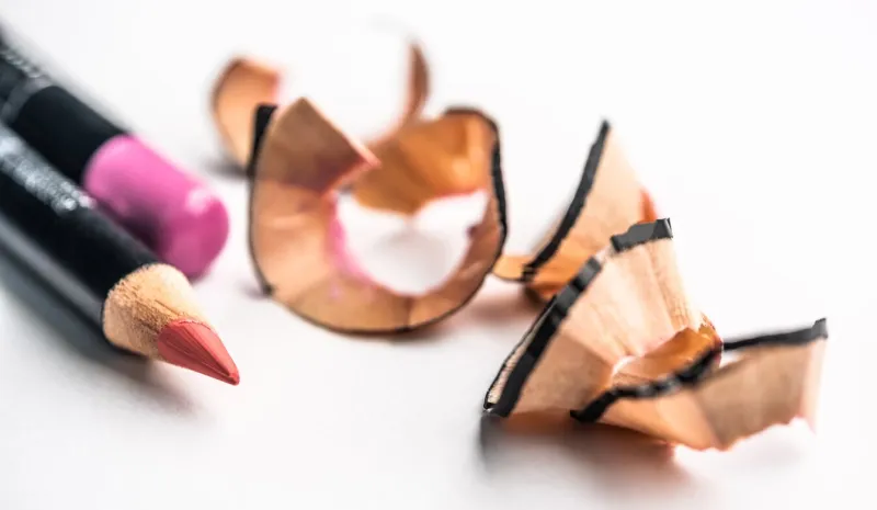 sharp red lip pencils lying next to shavings