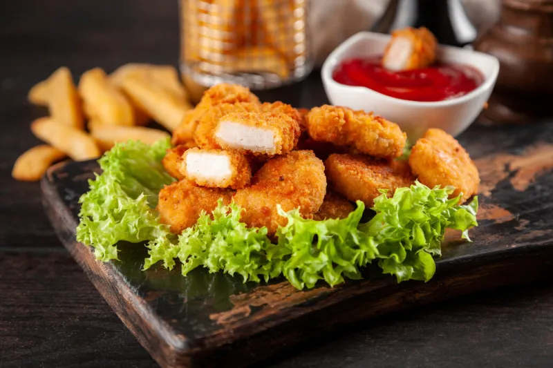 crispy chicken nuggets with lettuce and ketchup