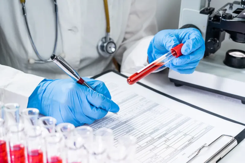 blood test tubes senior female scientist examining blood test tubes at her laboratory dna testing analysis profession specialist clinician experienced medicine healthcare doctor concept copyspace