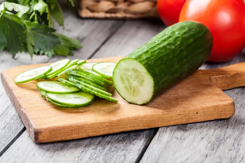 chopped vegetables  cucumber on cutting board selective focus