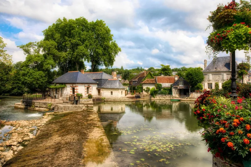 the old water mill and the mill pond as the indre river runs through azay-le-rideau in the loire valley, france