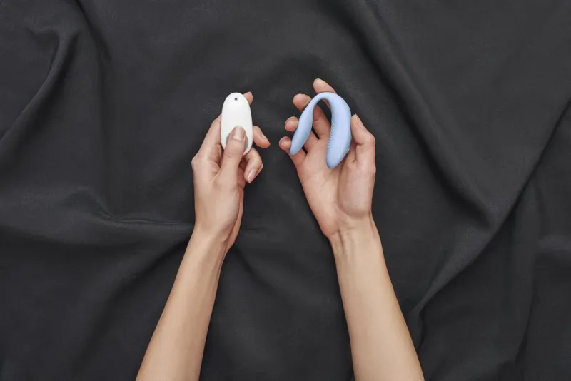 perfect choice female hands holding g-spot vibrator for women with remote control against of black silk shopping online sex toys for women