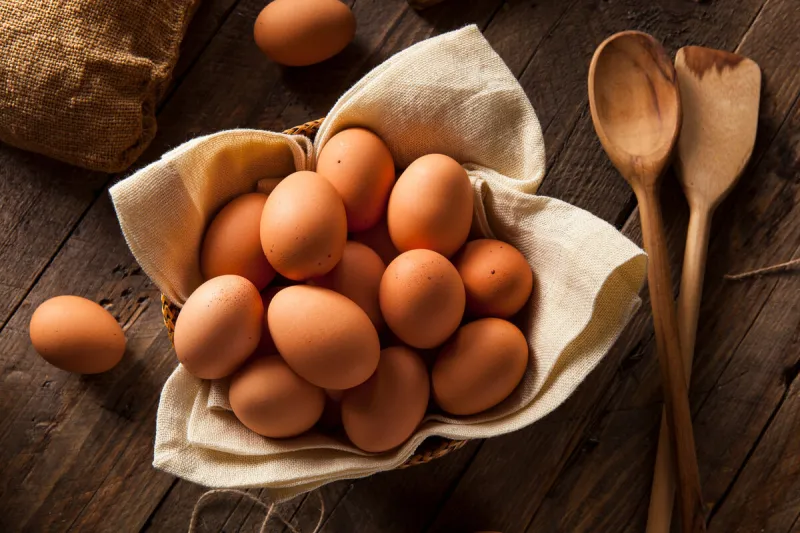 raw organic brown eggs in a basket