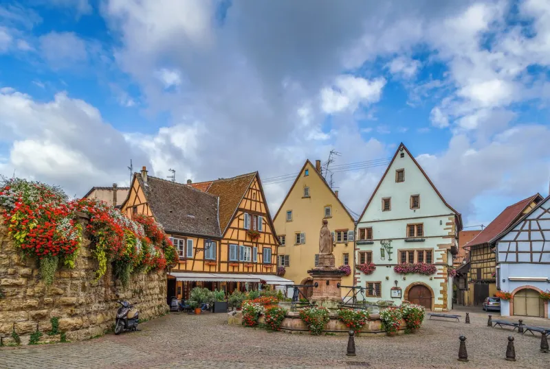 main square with fountain with statue of pope leo ix in eguisheim, alsace, france
