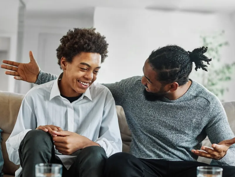 father son family man child conversation talking parent boy happy discussion communication together togetherness bonding care black home talk love dad fun leisure joy