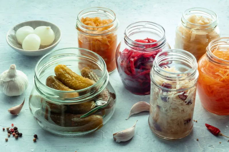 fermented food homemade vegetable preserves sauerkraut, pickles, kimchi etc in glass jars canning for winter healthy probiotic diet