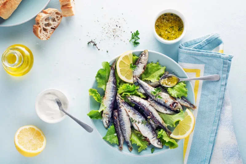 grilled sardines with lemon and herbs close up healthy vegetarian fish meal