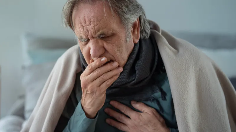 portrait of coughing old man