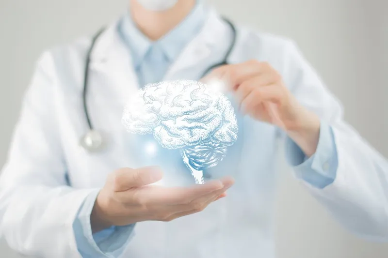 female doctor holding virtual volumetric drawing of brain in hand handrawn human organ, copy space on right side, raw photo colors healthcare hospital service concept stock photo