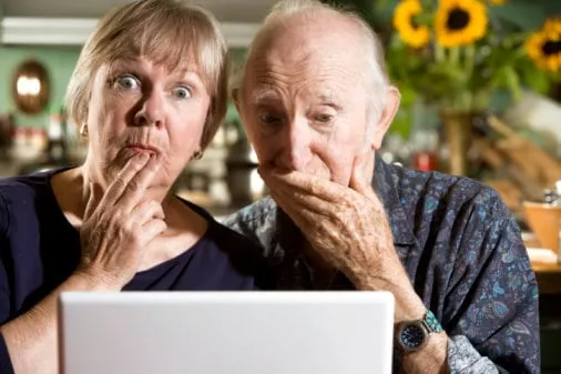 perplexed senior couple with a laptop computer