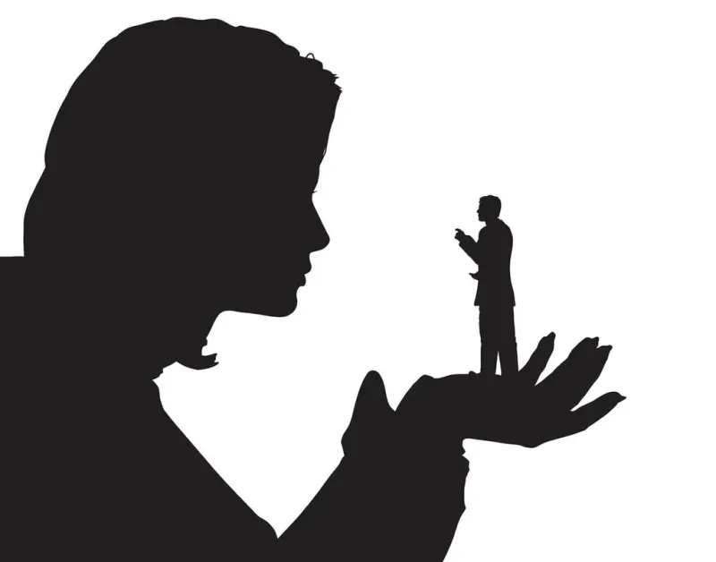 editable vector silhouette of a miniature man in the palm of a woman's hand with both figures as separate objects hi-res jpeg file included