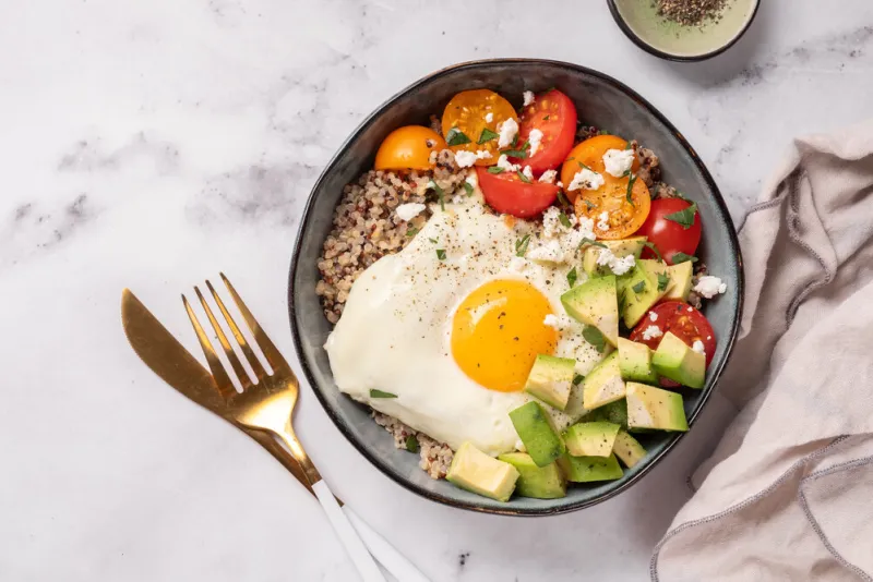 keto diet plate quinoa, avocado, egg and tomatoes healthy food, ketogenic diet