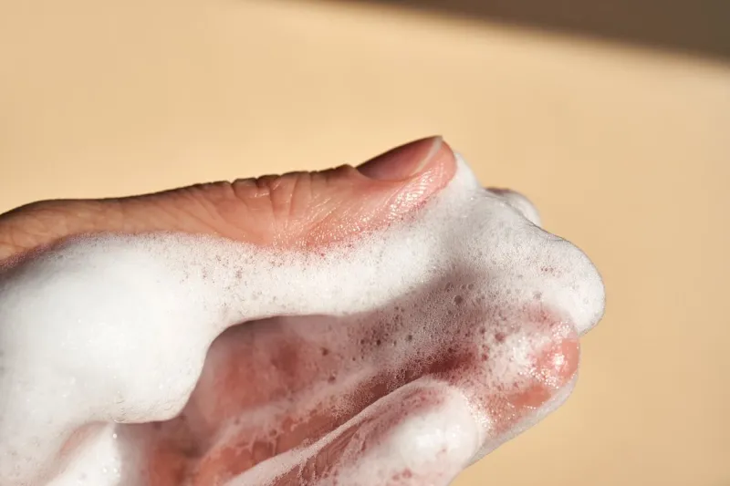 photo of the texture of cosmetic foam or soap on the background of the hand
