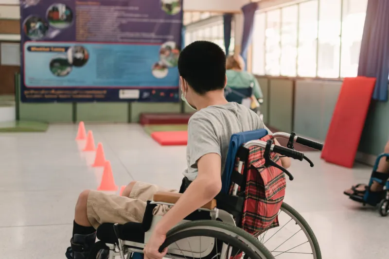 young man with disability practicing wheelchair by an occupational therapist teacher on ramps for people with disabilities,lifestyle in the education age and practicing essential skills in daily life