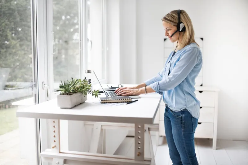 businesswoman working at ergonomic standing workstation