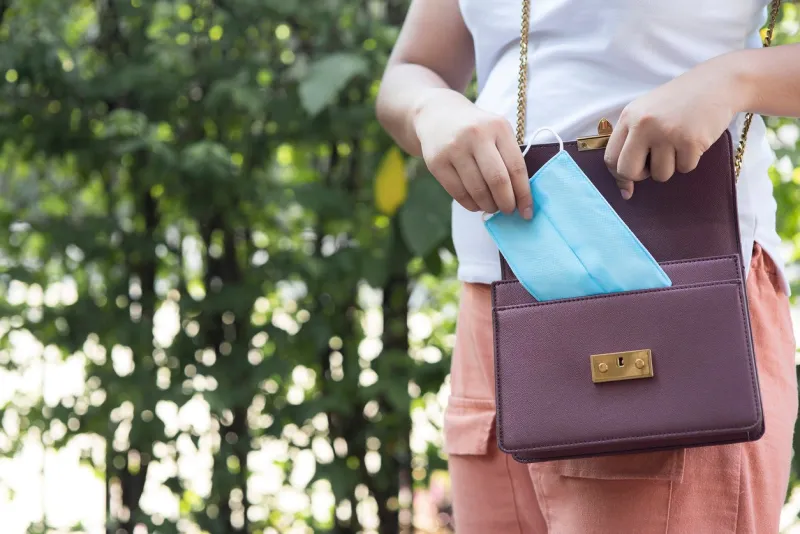 women carrying a bag with a protective mask from virus covid-19