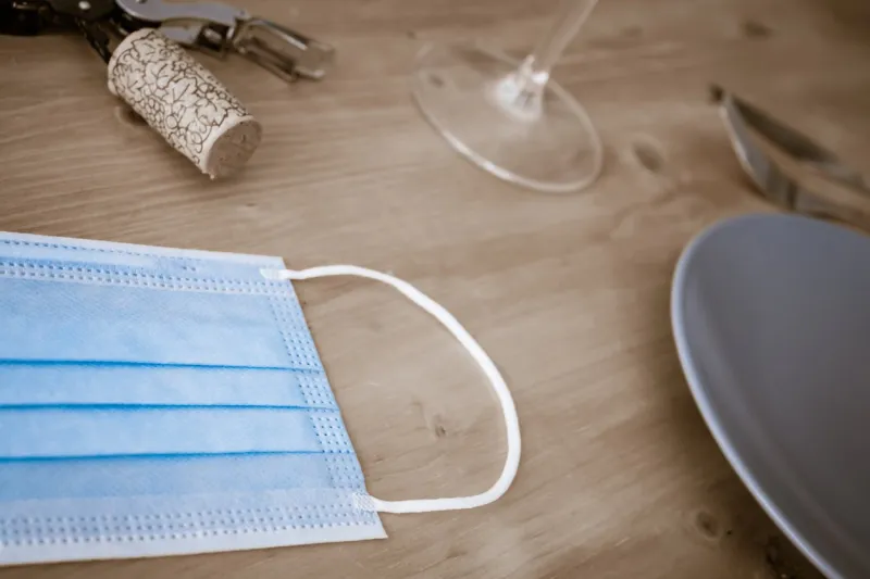 composition based on a face mask and restaurant objects concept of the reopening of the restaurants after the covid pandemia (2)