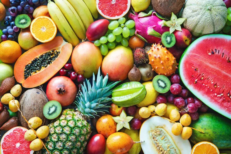 food background assortment of colorful ripe tropical fruits top view