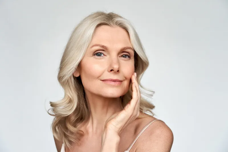 beautiful gorgeous 50s mid aged mature woman looking at camera isolated on white mature old lady close up portrait healthy face skin care beauty, middle age skincare cosmetics, cosmetology concept