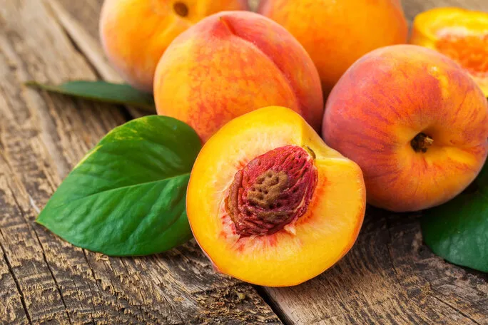fresh peaches on wood background