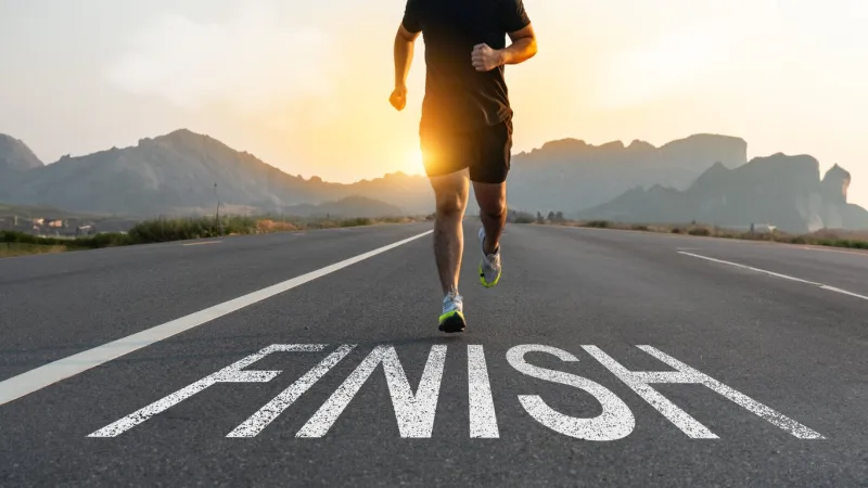 runners running towards the finish line success concept