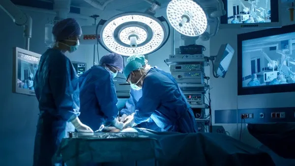 medical team performing surgical operation in modern operating room