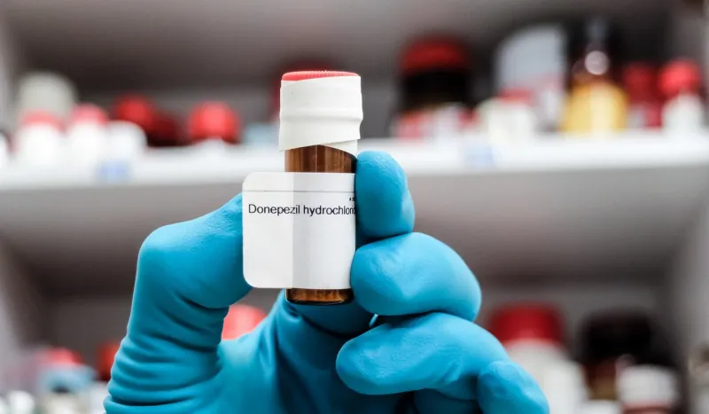 a glass vial of donepezil - a medication used to treat dementia of the alzheimer's type