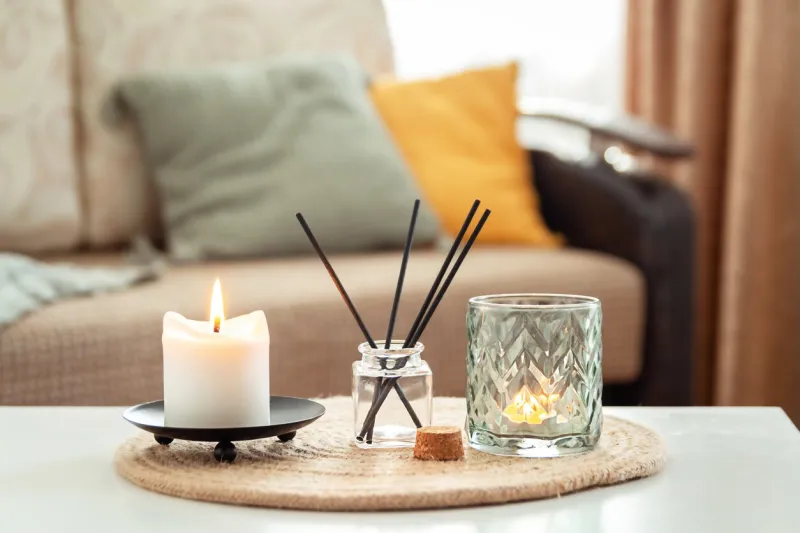 scented candles and aroma incense sticks on table in living room aromatherapy, home fragrance concept of home relaxation and anti stress