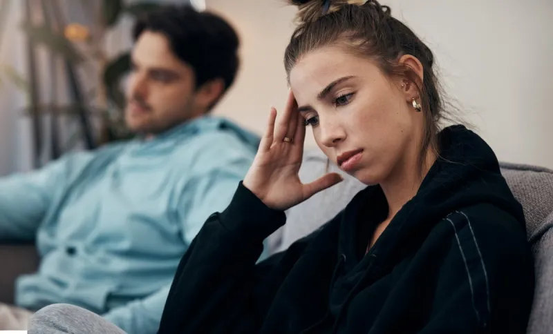 frustrated couple, headache and fight on sofa in divorce, disagreement or conflict in living room at home man and woman in toxic relationship, cheating affair or dispute on lounge couch at house