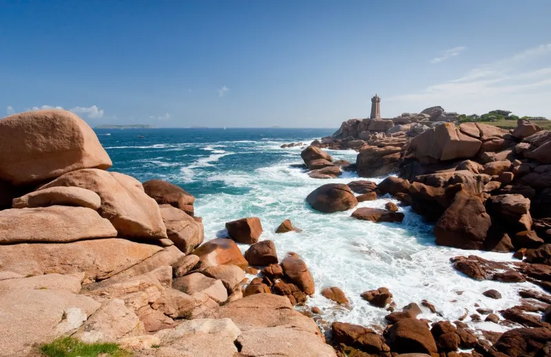 lighthouse in the rocks on pink granite coast in france