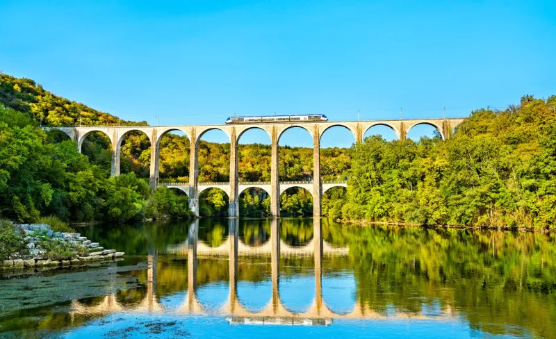 regional train on the cize-bolozon viaduct across the ain gorge in france