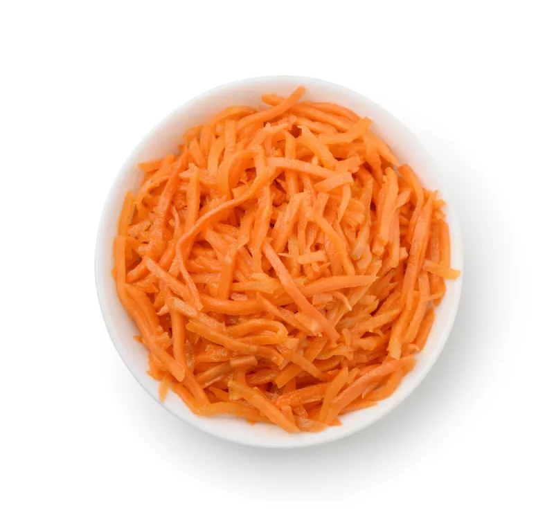 top view of grated carrot in bowl isolated on white