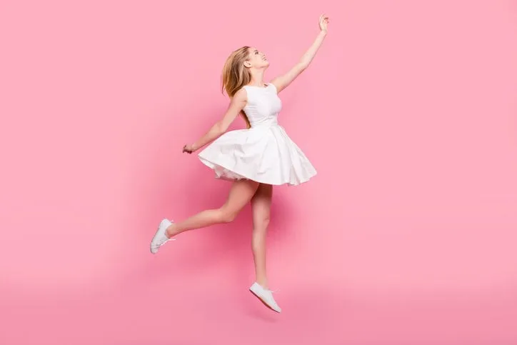 full-size full-length side view portrait of beautiful attractive carefree tender gentle innocent stylish excited cheerful girl jumping up wants to touch sky isolated on background copy-space
