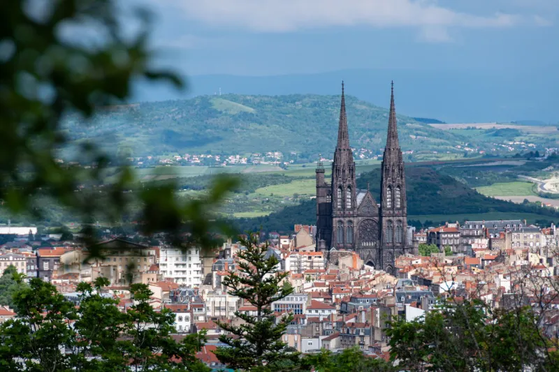 distant view of the notre-dame-de-l'assomption cathedral in clermont-ferrand, france, built in black volvic stone, in the french department of puy-de-dôme, in the auvergne rhône-alpes region
