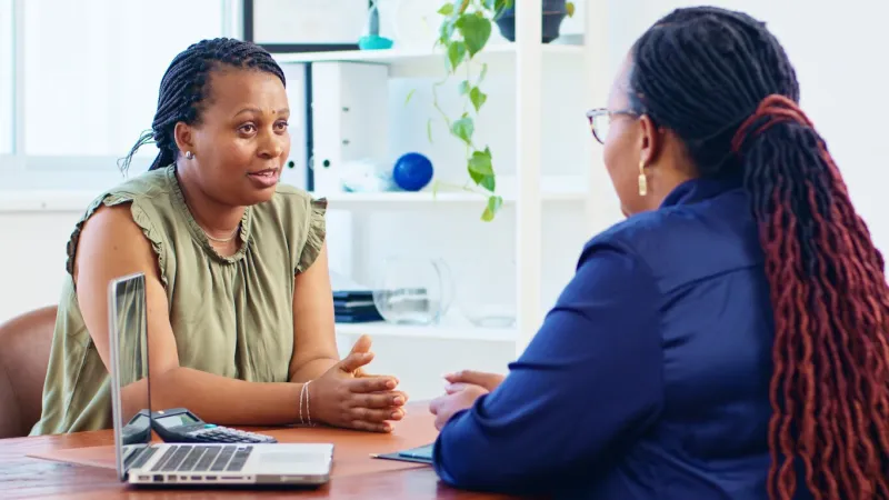 two women engage in a professional consultation, exchanging ideas in a modern office setting the meeting highlights communication and collaboration