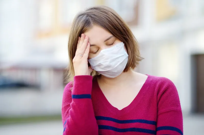 young woman wearing a protective mask in public place safety during covid-19 outbreak pandemic of coronavirus